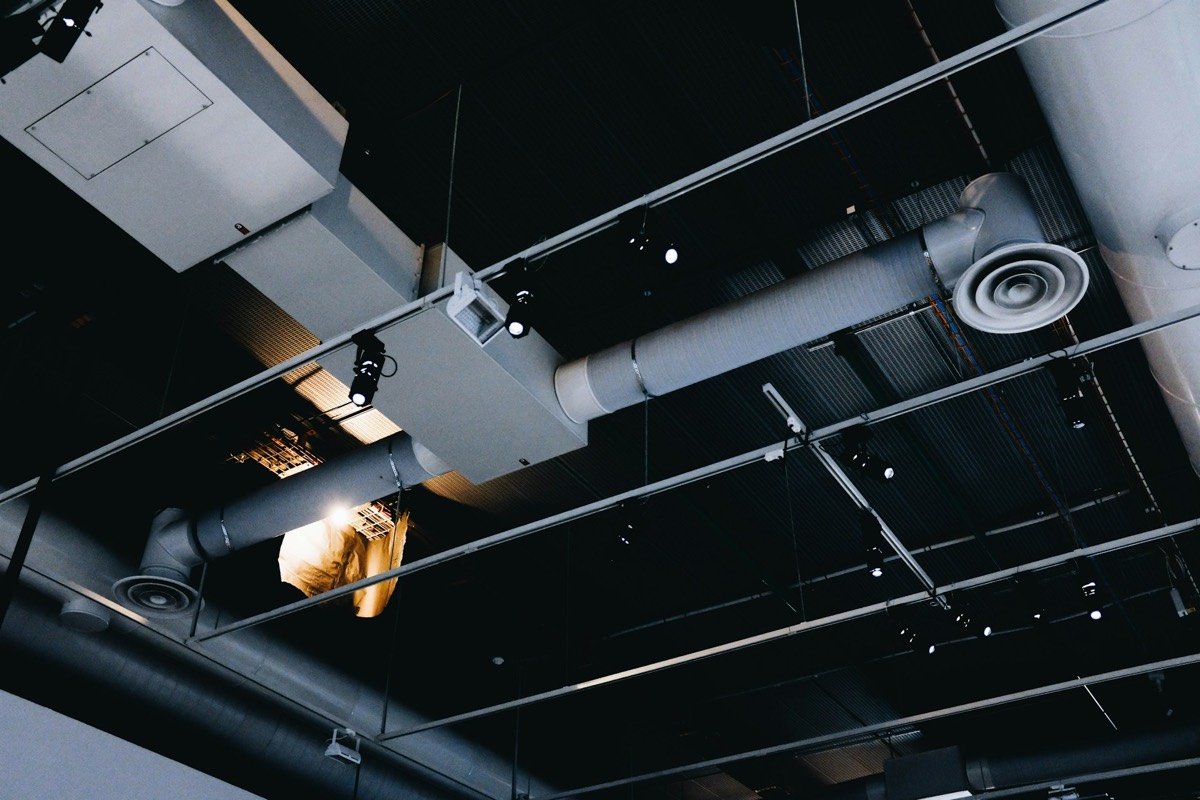 Exposed HVAC ductwork and air diffusers along a ceiling